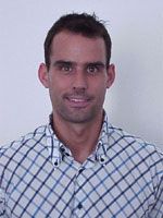 Mann mit kurzem Haar in einem karierten Hemd vor einem hellen Hintergrund.