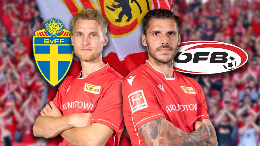 Two soccer players in red jerseys stand next to each other, with club logos in the background and fans in the arena.