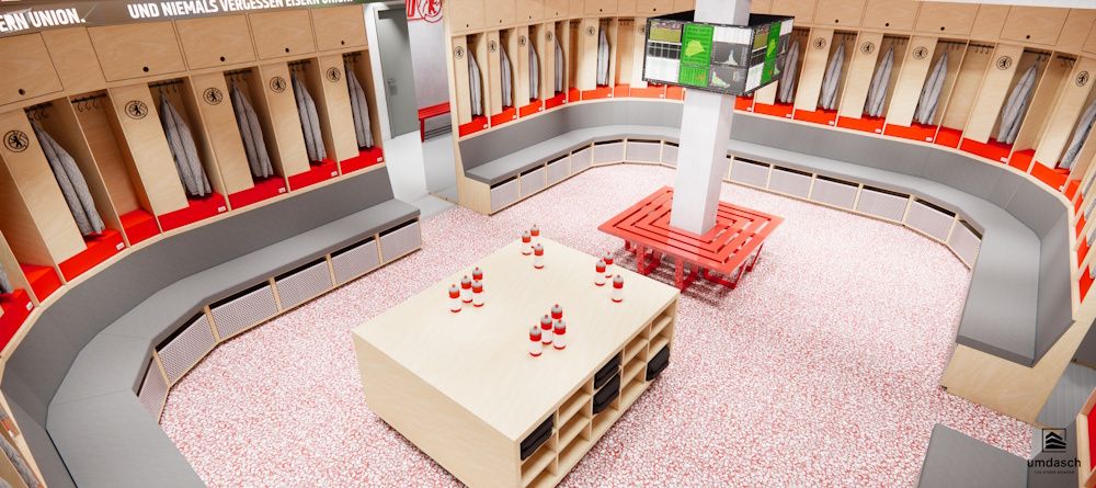 Umkleideraum mit Holzkabinen, zentralem Tisch und Bildschirm, dekoriert in Rot und Beige mit einem modernen, sauberen Design.