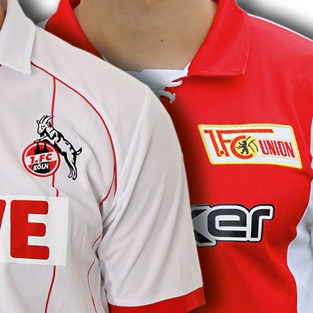 Zwei Personen tragen Fußballtrikots: eines in Weiß mit einem Ziegenlogo und das andere in Rot mit einem Vereinslogo.