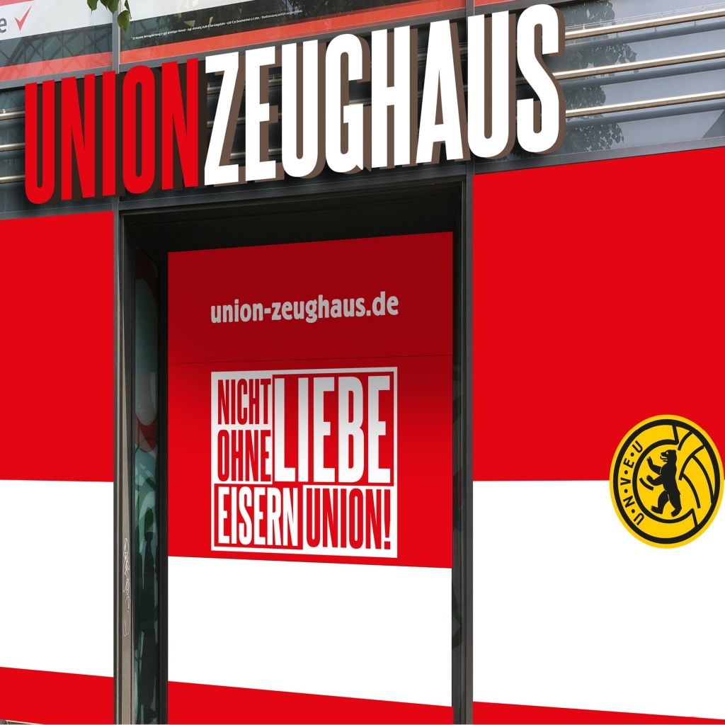 Ein Geschäft namens "Union Zeughau" mit roter und weißer Fassade und einem Logo, das eine Biene zeigt.