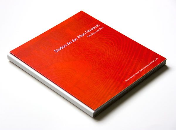 Ein rotes Buch mit dem Titel „Städion An der Alten Försterei“ auf dem Cover, liegend auf einem weißen Hintergrund.