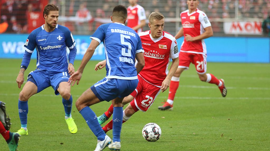 Football match between Union Berlin and Darmstadt with players in action on the field.
